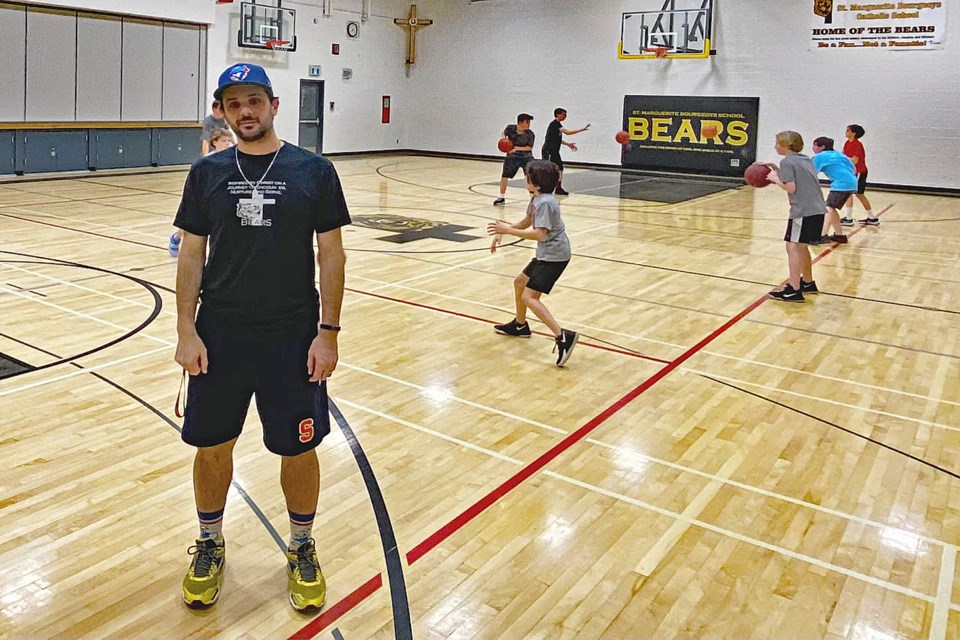 Christian Damgaard, the new athletics director at St. Marguerite Bourgeoys Catholic School, at a student basketball practice this month. He is committed to reshaping the sport programs at the school. Submitted photo