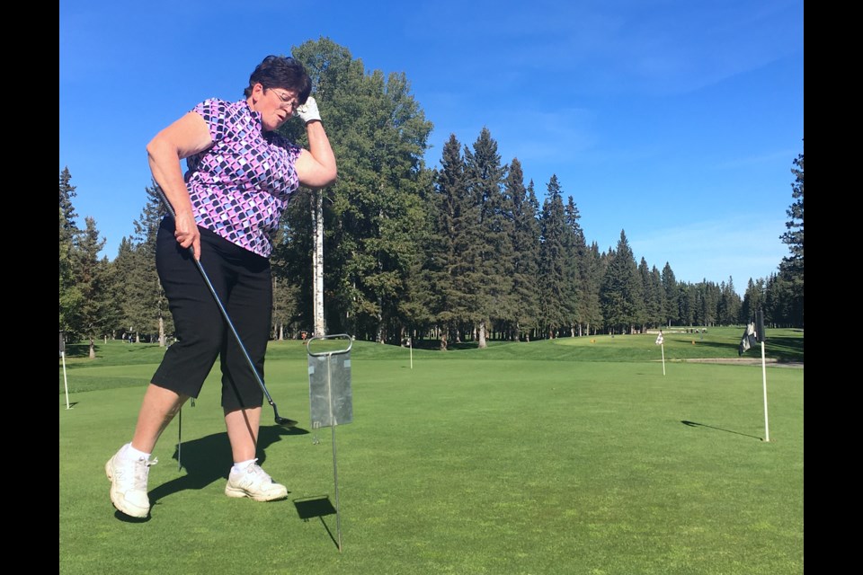 Cremona resident Karla Ware, who on Friday, Sept. 15 came out to play at the Sundre Golf Club for a STARS fundraising tournament with three friends from around Mountain View County, celebrates after successfully sinking the last two out of three balls she had as part of a putting challenge. 
Simon Ducatel/MVP Staff