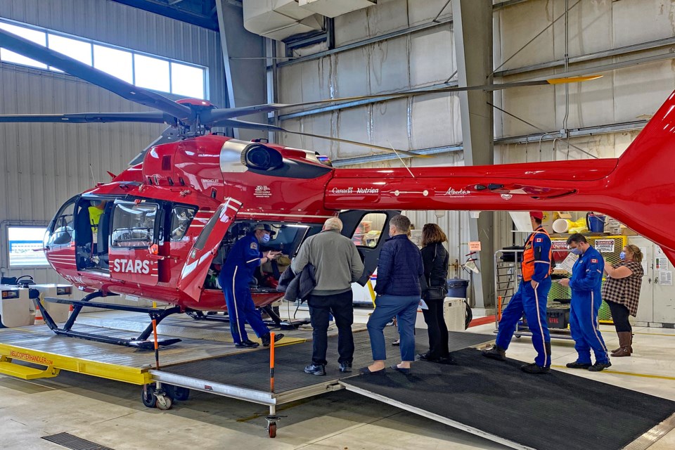 The Innisfail delegation receives a tour and lesson from a STARS staff member on one of the new 10 Airbus H145 helicopters STARS acquired since 2019 to replace the older BK117 models. This helicopter was parked in the hanger at STARS' Calgary base. Martin Ebel/STARS