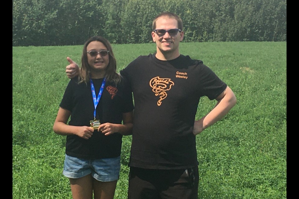 Gold medal winner Stella Bos and Olds Rapids coach Wesley Wilks pose for a photo.
Photo submitted