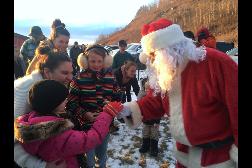 SEEIN’ SANTA – Courtesy of an escort from No Surrender Fire Services, Santa Claus dropped by the ball diamond behind River Valley School on his way into town for Sundown in Sundre activities. Before settling in for the evening for family photos at the Sundre and District Museum, Santa also made an appearance over at the Sundre Seniors Supportive Living centre to spread some holiday cheer among the residents.
Simon Ducatel/MVP Staff