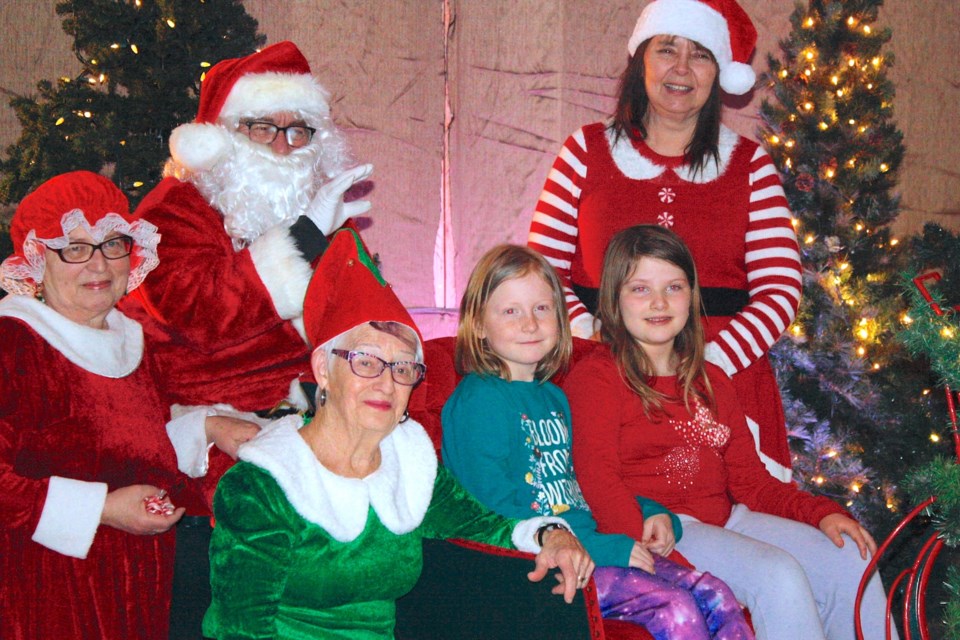 Escorted by a whole entourage of merry helpers, Santa Claus brought his sleigh to the Sundre and District Museum on Dec. 6-7 as part of Sundown in Sundre activities to have photos taken with youngsters eager to see the jolly old magical elf. Among them were Piper Free, 8, left, and her friend Eliana Austin-Bergen.
Simon Ducatel/MVP Staff