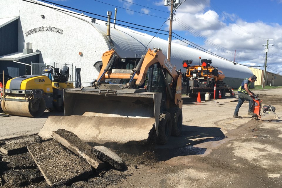 While crews work to complete the municipality’s major overhaul of underground infrastructure along the Highway 27-Main Avenue corridor, another was busy on Tuesday, May 14 tackling an unrelated road job at 2nd Avenue NW near the Sundre Arena and local schools.  
Simon Ducatel/MVP Staff