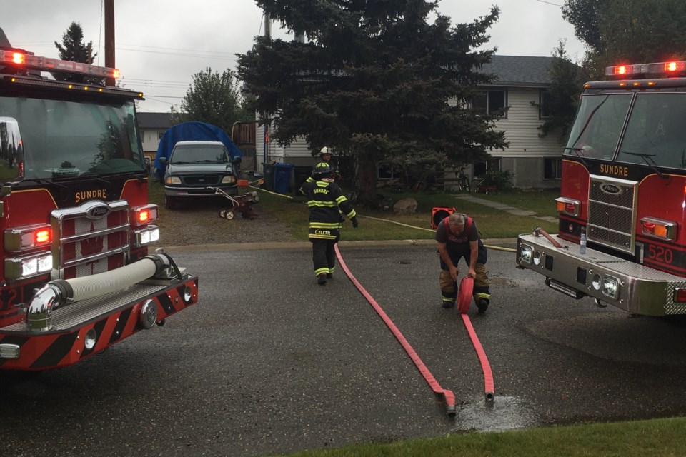 A structure fire that broke out in Sundre’s northeast subdivision along the Royal Purple Park playground on the afternoon of Thursday, Sept. 12 completely gutted the residence’s basement and caused smoke damage to the main floor but was ultimately contained without spreading to neighbouring properties as a result of the quick response of firefighters. 
Simon Ducatel/MVP Staff