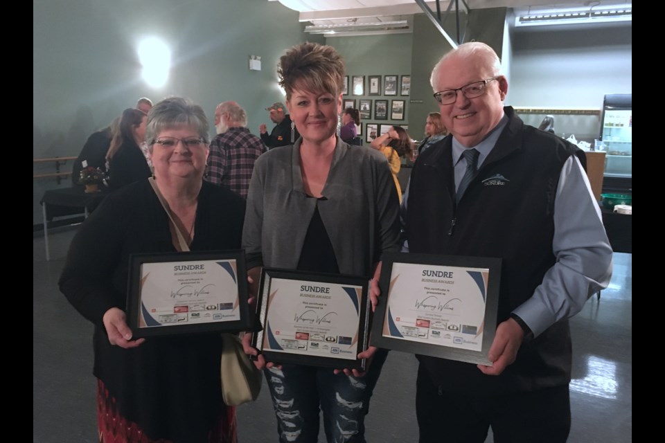 Flanked by Sundre & District Chamber of Commerce president Lois Warnock to the left and Sundre mayor Richard Warnock, Tessa Crouch – whose business Whispering Willows swept up three categories at the 2022 Sundre Business Awards – said she wasn’t expecting to win any awards, let alone three, especially Business of the Year 1-10 Employees.  
Simon Ducatel/MVP Staff