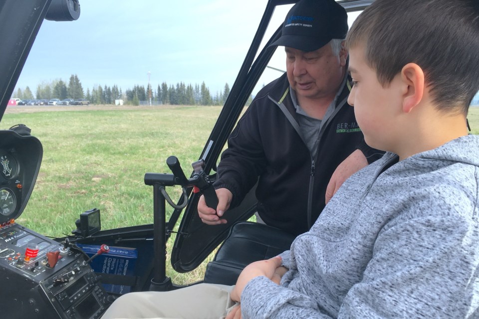 Gavin Decoste, 12, was not about to pass up on the opportunity to sit in the pilot’s seat of a helicopter owned and flown into the Sundre Airport for the return of the Mother’s Day Fly-in Breakfast by Alan Acker, a member of the Rocky Mountain Flying Club who enjoys coming out for the event every chance he gets. 
Simon Ducatel/MVP Staff