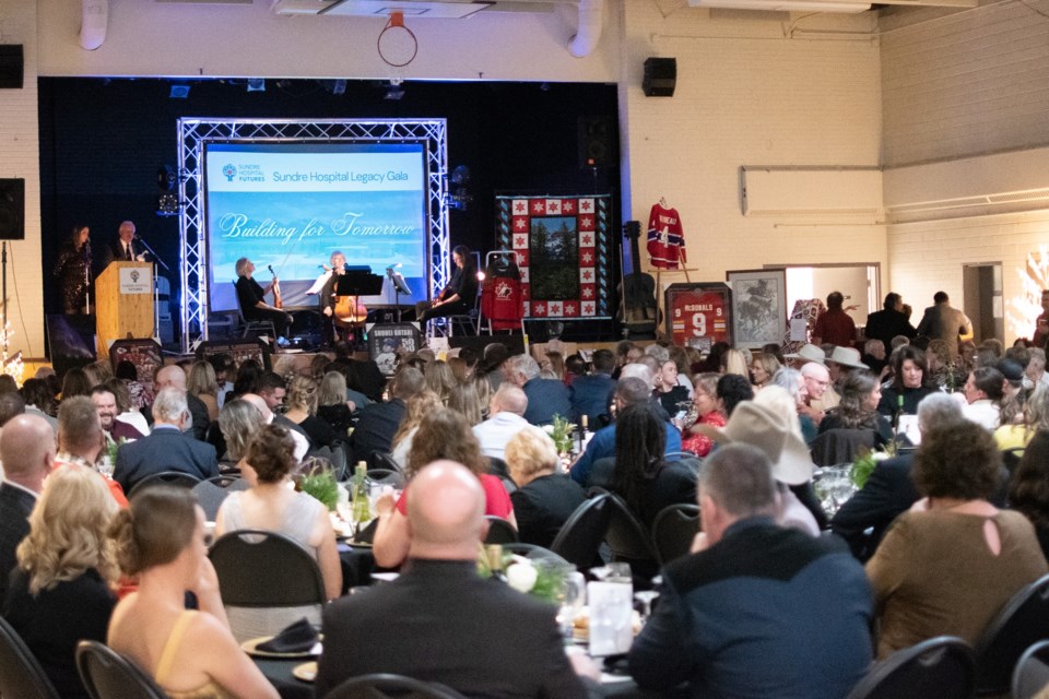 Sundre Hospital Futures Committee chair Gerald Ingeveld, at the podium on the Sundre Community Centre's stage, addresses a packed house this past Saturday night during the seventh edition of the Sundre Hospital Legacy Gala.  
Photo courtesy of Alandra Corrigan