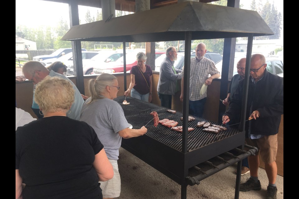 Members of the Royal Canadian Legion Sundre Branch #223 fired up on Thursday, Aug. 15 the grill immediately adjacent the building’s north-facing wall for the summer’s monthly barbecue fundraiser. 
Simon Ducatel/MVP Staff