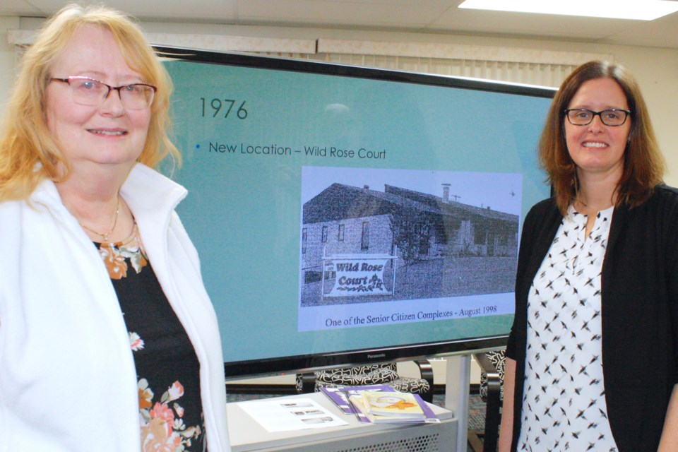 The Sundre Municipal Library hosted on Dec. 11 a celebration recognizing its 75th anniversary.  Charlene Siegfried, left, was hired in 1982 as the first paid librarian to work at the library, which at the time was located in the basement at the Wild Rose Court, and stayed in that role for 15 years. Joy Willihnganz, who presented a historical look at not only the library but Sundre as well, has been the manager since 2022. 
Simon Ducatel/MVP Staff