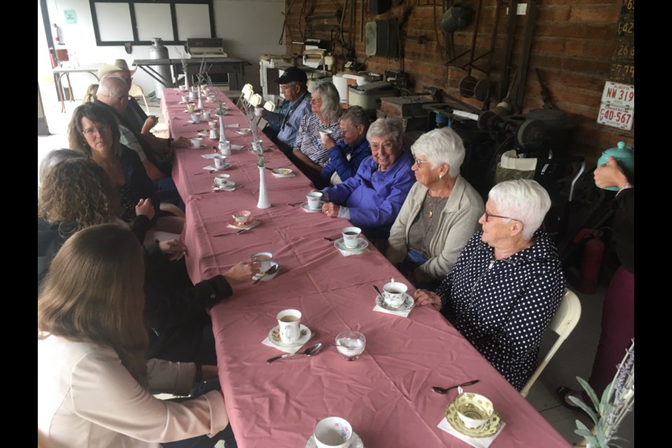 Rather than outright cancel the third edition of the Strawberry Tea at the Sundre and District Museum on account of less-than-ideal weather with an overcast sky on Friday, Aug. 16 that resulted in light, intermittent rains, executive director Carrie Couch instead opted relocate the event into the covered area under the historic pioneer village grounds’ big barn. And while past events had volunteers donning period costumes as they poured tea, the affair was this time around scaled back a bit for simplicity’s sake.   
Simon Ducatel/MVP Staff