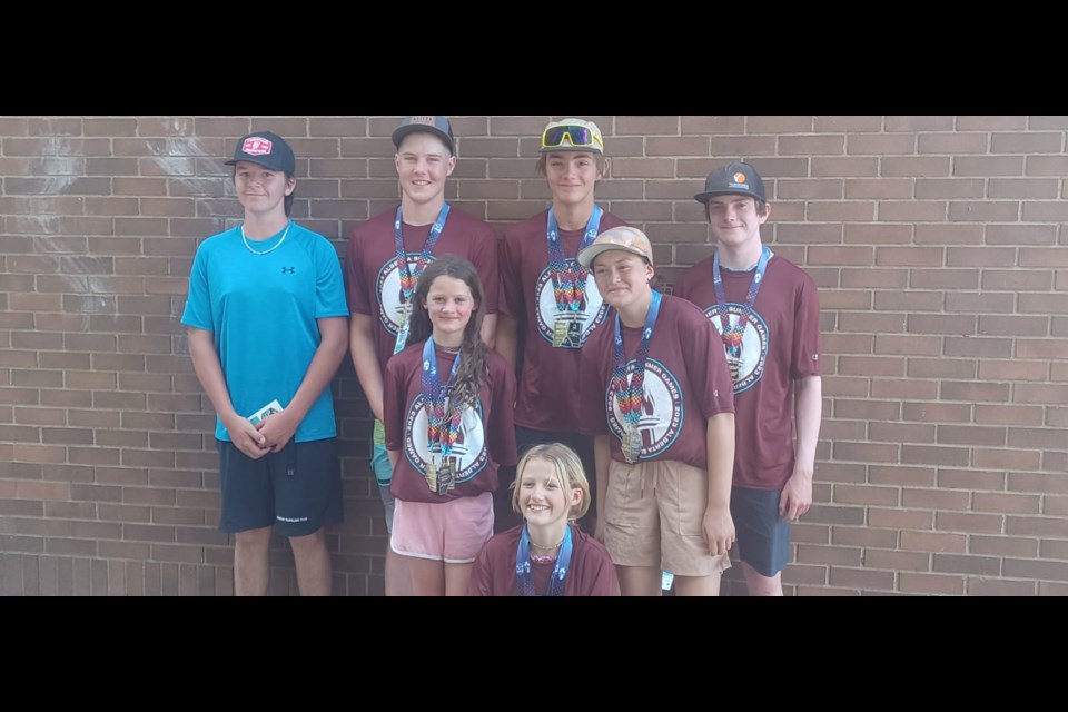 Sundre Paddling Club members Callum Hunter, back row left, Liam McElhinney, back row second from left, and Saffire Caron-Ladines, middle row right, joined the Zone 2 team to compete in the 2023 Alberta Summer Games. 
Submitted photo