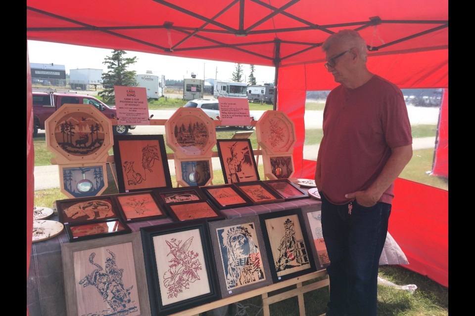 Sundre resident Barry Lloyd, a wood working artist who makes carvings using a scroll saw to create finely detailed pieces, was among several vendors who set up a table under one of the canopy tents on Thursday, Aug. 8 during the new trial West Side Pop Up Market set up by the Town of Sundre, which started Aug. 1 and ends Sept. 5.
Simon Ducatel/MVP Staff