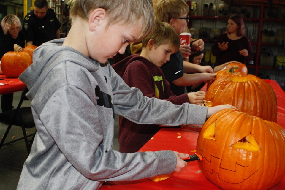 Sundre residents Deacon Christensen, 10, foreground, and his little brother Cooper, 8, were among dozens of children who came out to the local fire hall on Wednesday, Oct. 23 to carve out jack-o’-lanterns during the Sundre Fire Department’s annual community pumpkin carving event. Mom Ashley, who appreciates the opportunity that is made possible courtesy of the fire department that provides the space and tools as well as Freson Bros. that contributes an abundance of the gourds, said the boys enjoy coming out every year.
Simon Ducatel/MVP Staff