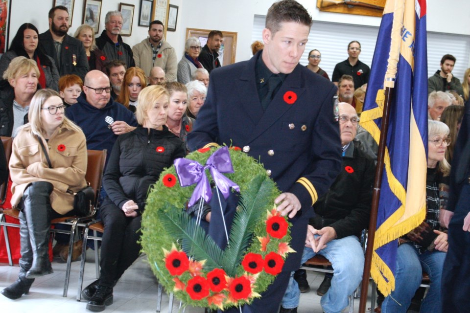 Ryan Martens, a captain with the Sundre Fire Department, lays a wreath on Nov. 11 during the community Remembrance Day service at the Royal Canadian Legion Branch #223 in Sundre, which hosted the ceremony for the first time in years. The hall was packed to capacity with people standing at the back and vehicles parked as far as a couple of blocks away. 
Simon Ducatel/MVP Staff