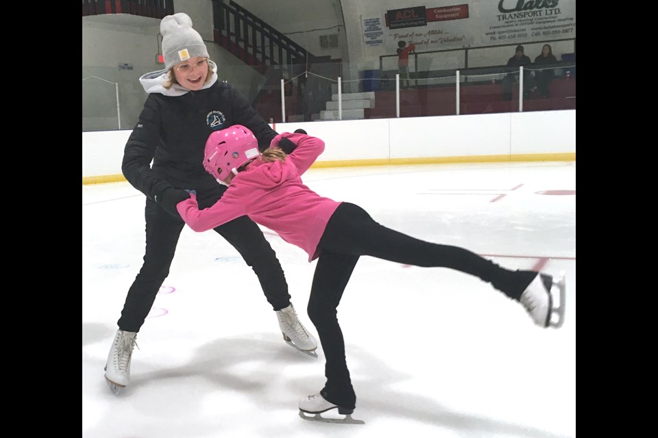 Maddy Byrt, an instructor with the Sundre Skating Club, helps Rebecca Blackhurst to improve her balance on Tuesday, Oct. 11 at the Sundre Arena during a practice. 
Simon Ducatel/MVP Staff