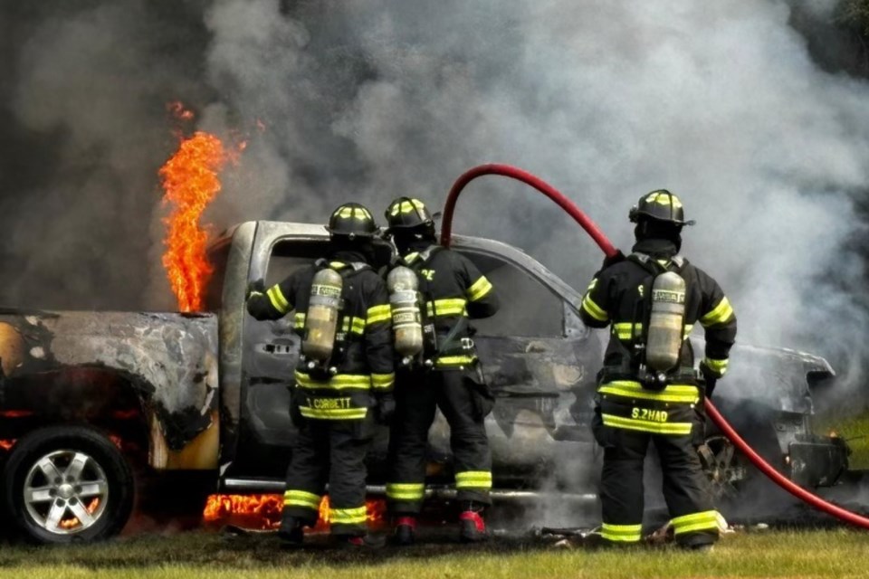 Members of the Sundre Fire Department move in to attack a fully engulfed vehicle fire earlier today on a rural property along Range Road 52 on the east side of town south of Highway 27. 
Submitted photo