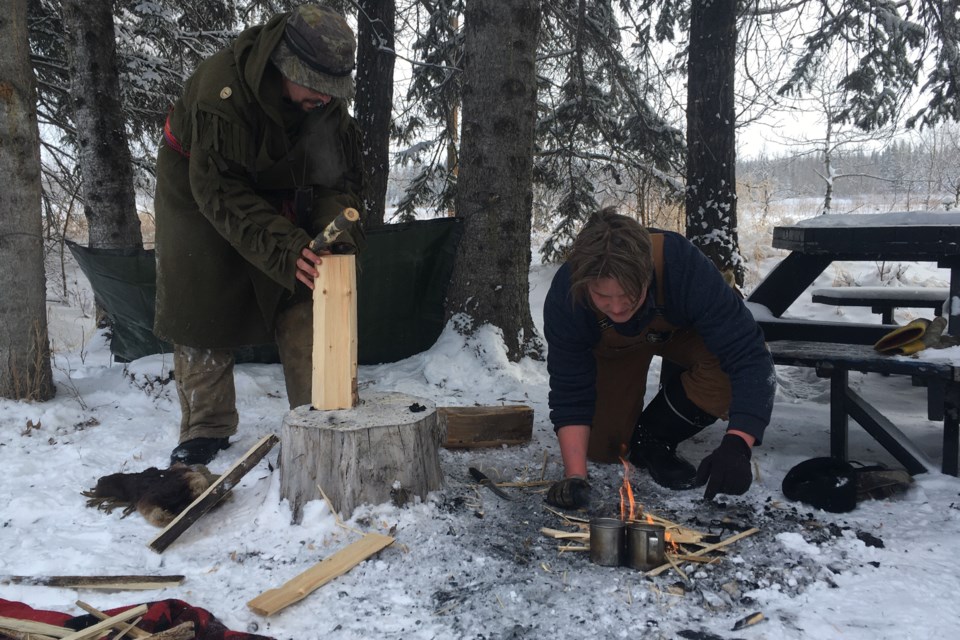 Christian White carefully tends to a fire he and teammate Robert Edwards got started as part of the challenges participants had to successfully complete as quickly as possible during the return of the Mountain Survivalist competition, which was hosted on Monday, Feb. 21 as part of the Family Day long weekend’s WinterFest activities. 
Simon Ducatel/MVP Staff