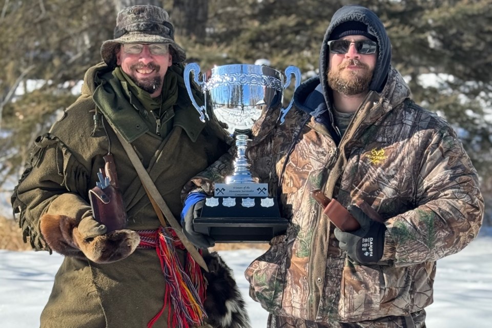 Team Fire and Ice Robert Edwards, from Ponoka, left, and Brad Keith, from Red Deer, hold the Mountain Survivalist Competition Survivalist Cup. They were one of five teams of two who tested their skills amid cold weather on Monday, Feb. 17 at the Greenwood Campground. Photo courtesy of Jon Allan