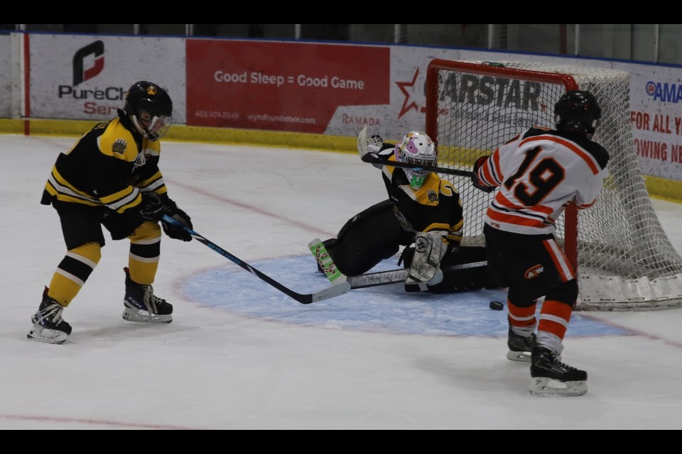 Grizzly goaltender Elinor Lutz gets ready to stop a puck fired by a Drumheller Dragon player during the Grizzlys invitational U11 hockey tournament, held Feb. 14-16 at the Olds Sportsplex. Trailing on the play is Grizzly Greysen Hardy.
Doug Collie/MVP Staff