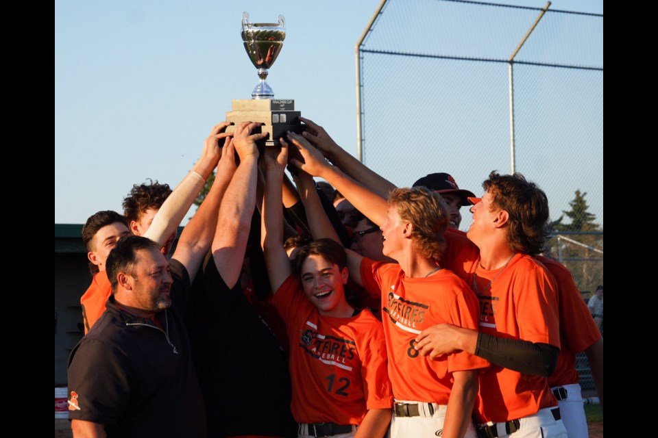 Members of the Rawlings Cup champion U16 Olds Spitfires reach for the trophy.
Photo submitted