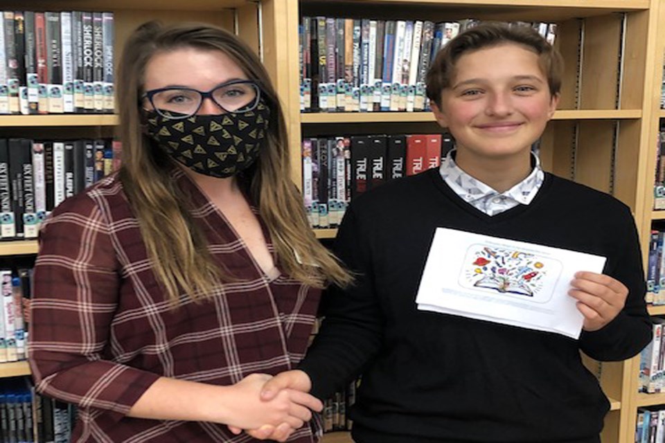 Haley Amendt of the Parkland Regional Library System (left) congratulates Innisfail's Sophie Bouw on winning the library card design contest.  Submitted photo