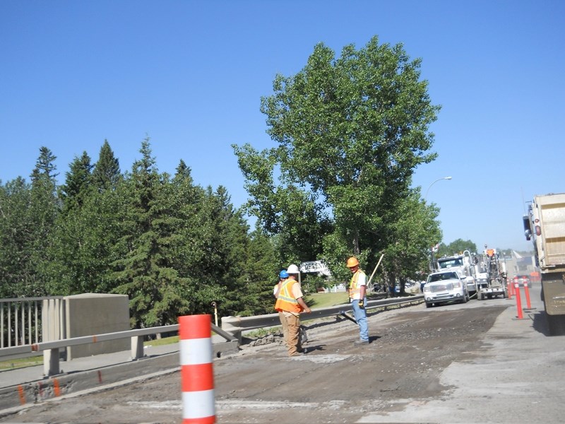 Alberta Transportation workers tear up the Main Avenue bridge as work got underway last week.