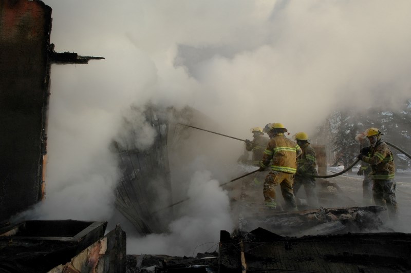 Crews work at a house fire