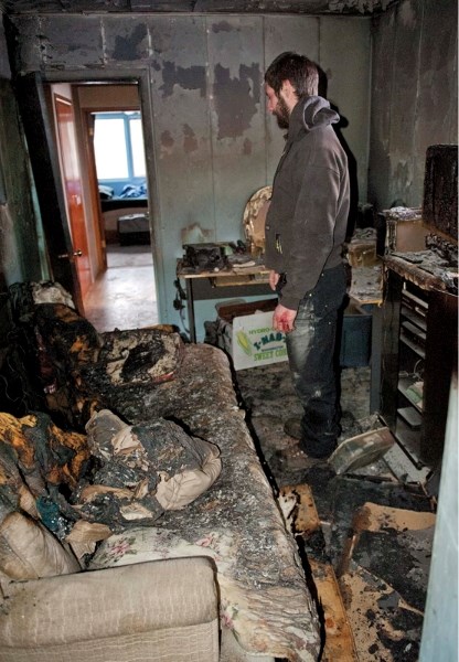 Mike Braun looks around the home he and his mother rent after fire swept through a room of a James River Road home north of Sundre last Thursday.