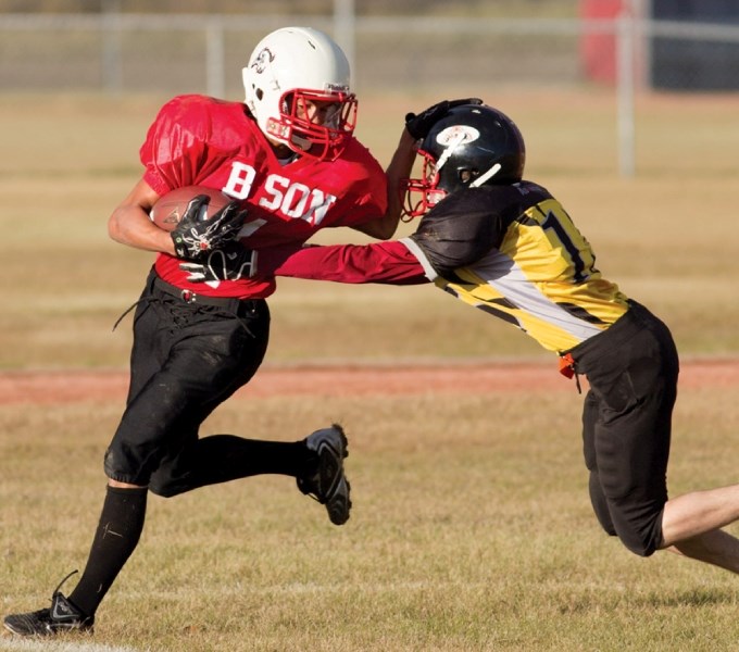 A Sundre Bisons player sheds a tackle from a Carstairs Tigers player just before scoring a touchdown during their game in Sundre last Thursday evening. Sundre won the game 37 