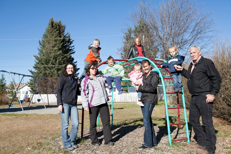 Sundre residents gather at one of the town&#8217;s six pocket parks. Citizens rallied on Oct. 15 to tell town council they were against a plan to eliminate the green spaces.