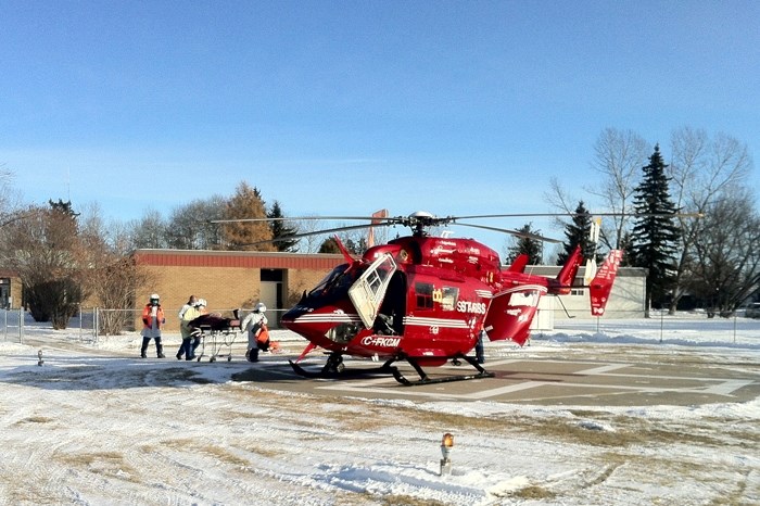 The STARS air ambulance prepares to leave the Sundre Medical Clinic with a patient shortly after 1 p.m. Monday after being delayed on the pad for an hour following a bomb