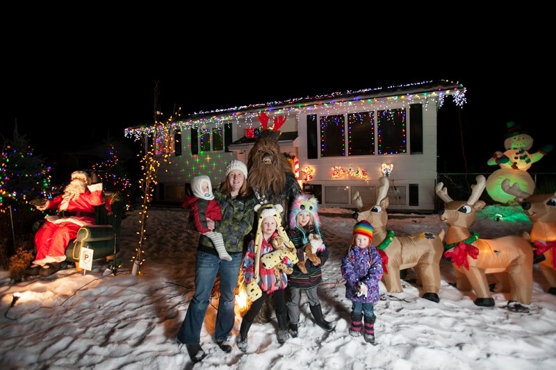 The Davidsons stand in front of their home with more than 10