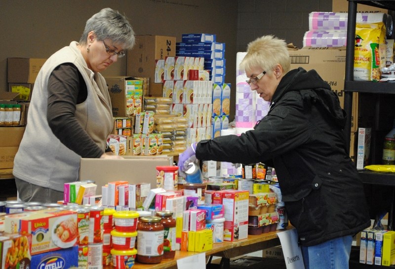 Santa&#8217;s Anonymous volunteers help with sorting food at the workshop on Dec. 16.