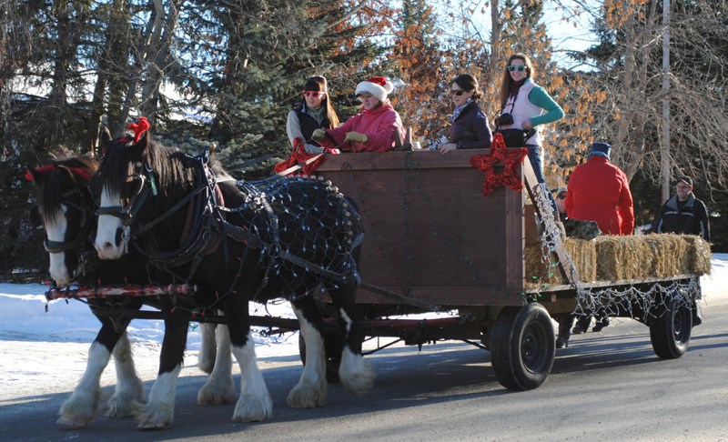 Horse-drawn wagons full of volunteers took to the streets of Sundre on Dec. 16 to collect donations for Santa&#8217;s Anonymous.