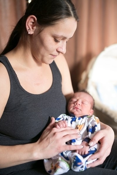 Megan Pittendreigh holds a sleeping Zayden Wyman at their home on Tuesday, Jan. 5.,