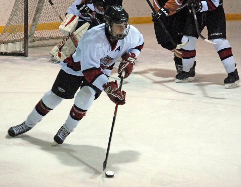 Sundre midget tier 3 Husky Carson Bartholow looks to get the puck out of his team&#8217;s zone during the last home game of the regular season on Friday, Feb. 12.,