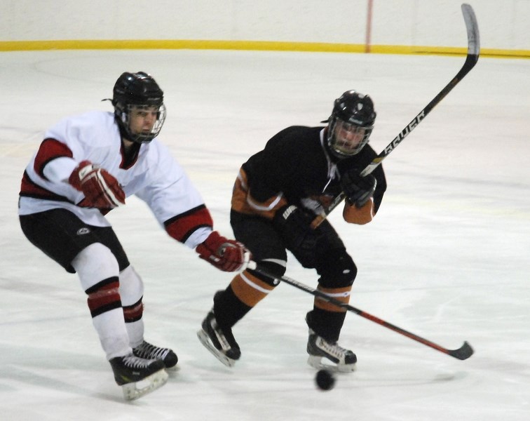 Midget Husky Carson Bartholow blocks a Rimbey player during first period action of Game 1 in a best-of-three series of the North Central Minor Hockey Association&#8217;s