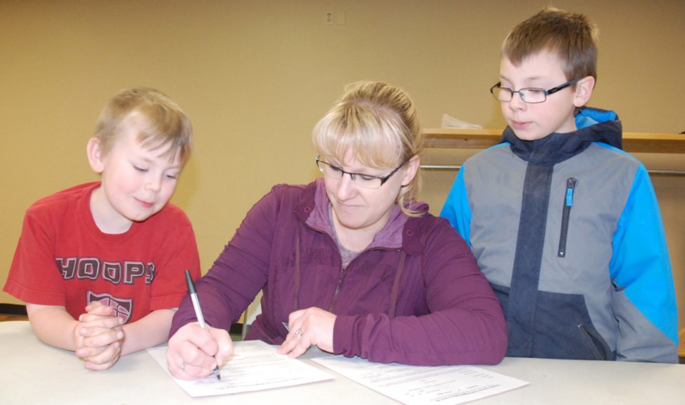 SOCCER AND MINOR BALL SEASONS COMING UP ó Mom Kim Simo and her sons Trig, 6, left, and Luke, 10, who moved north of Sundre about a year ago, came out for the Sundre Soccer