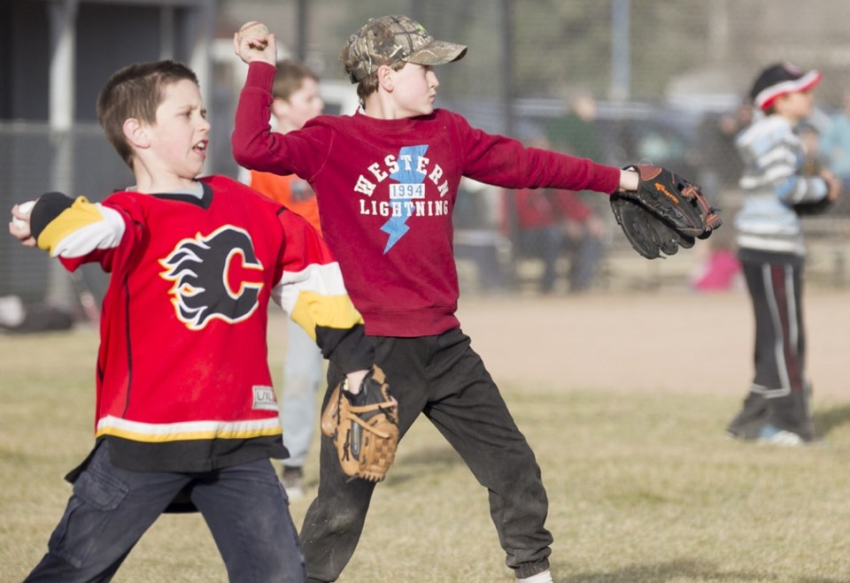 PLAY BALL! ó Colby Phillips, left, and Josiah Botheras throw balls to their partners during a Sundre Minor Ball Mosquitos U-11 team practice at the ball diamonds next to