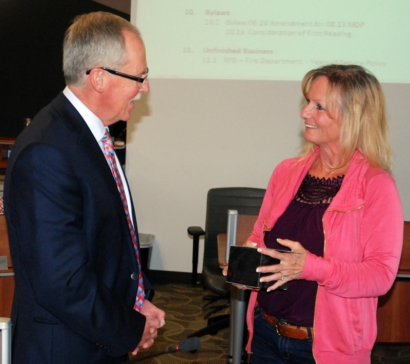 Mayor Terry Leslie shares a few words with former councillor Jodi Orr during council&#8217;s June 27 meeting, after presenting her with some gifts in recognition of her