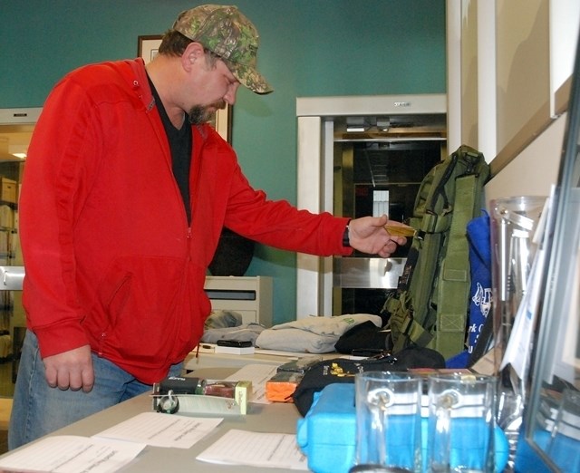 Russ Campkin, from Sundre, takes a look last week at some items donated for the local ATB branch&#8217;s annual United Way silent auction fundraiser. Half of the funds raised 