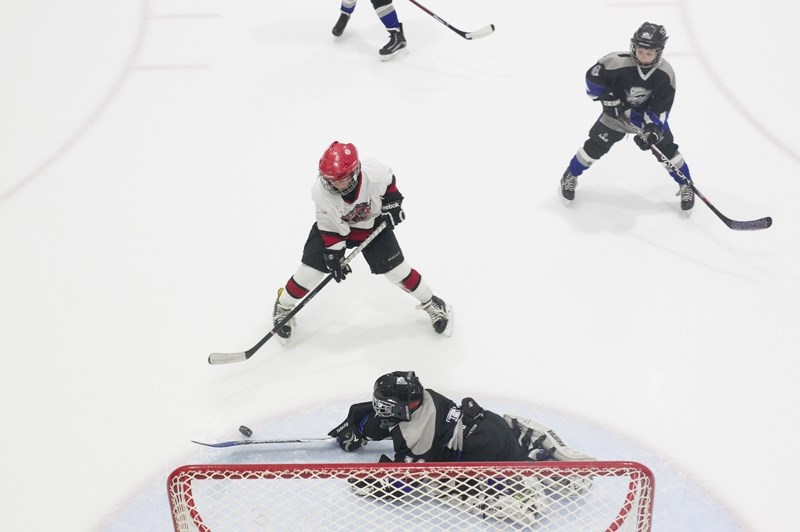 Sundre novice Husky Issac Thengs attempts to score on the Cremona Cowboys goaltender during the teams&#8217; game at the Sundre Arena on Saturday, Nov. 12. The Huskies hosted 