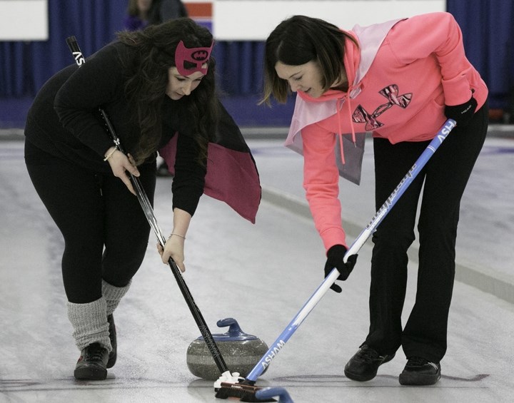 Kristy Willick, left, and Dani Rock sweep a rock during the 65th annual ladies bonspiel at the Sundre Curling Club on Saturday, Feb. 11. There were 22 teams competing in this 