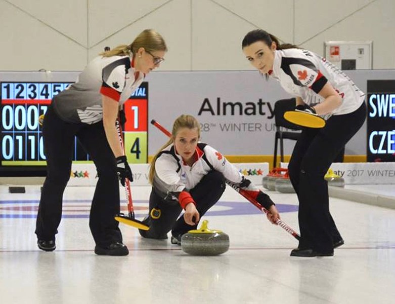 Former Sundre junior curler Danielle Schmiemann delivers a rock, flanked by teammates Taylore Theroux, left, and Taylor McDonald. The University of Alberta team that last