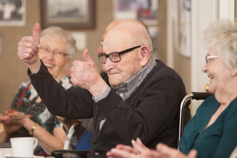 Surrounded by family, friends as well as well-wishers from throughout the community, John Whitesell Sr. beams an enthusiastic double thumbs-up at an event celebrating his