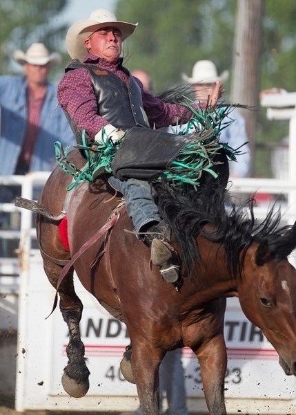 Dantan Bertsch grimaces as he clings on during his run in the bareback riding event of the Sundre Pro Rodeo&#8217;s opening performances on Friday, June 23.