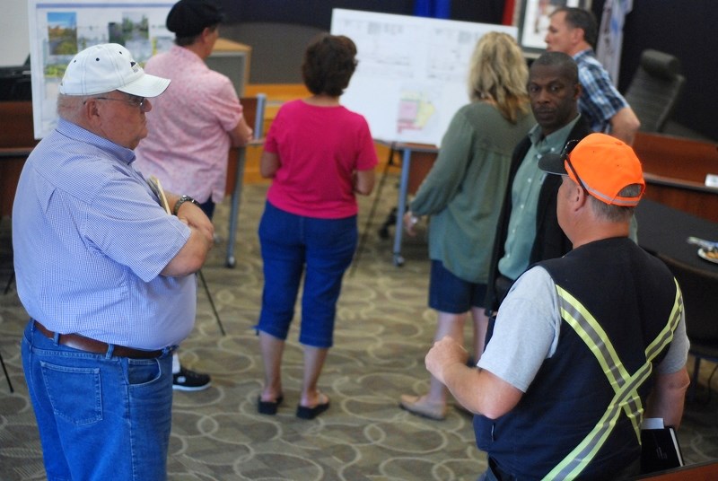 Gerald Moore, who has lived with his wife Pat for about nine years on Sixth Avenue SW north of the new Mountain View Seniors&#8217; Housing facility, chats with Jim Hall,