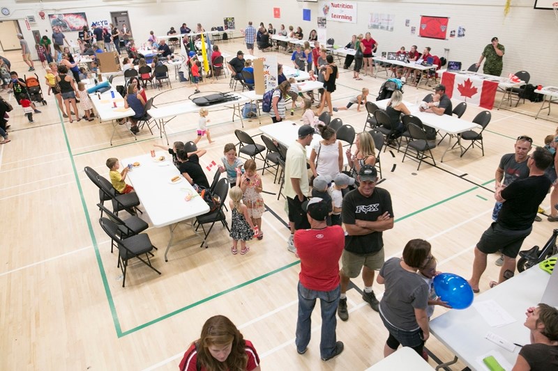 People browse through the offerings at the 9th Annual Sundre Community Recreation Registration &#038; RVS Welcome Back BBQ held Sept. 7 at the community centre, the library