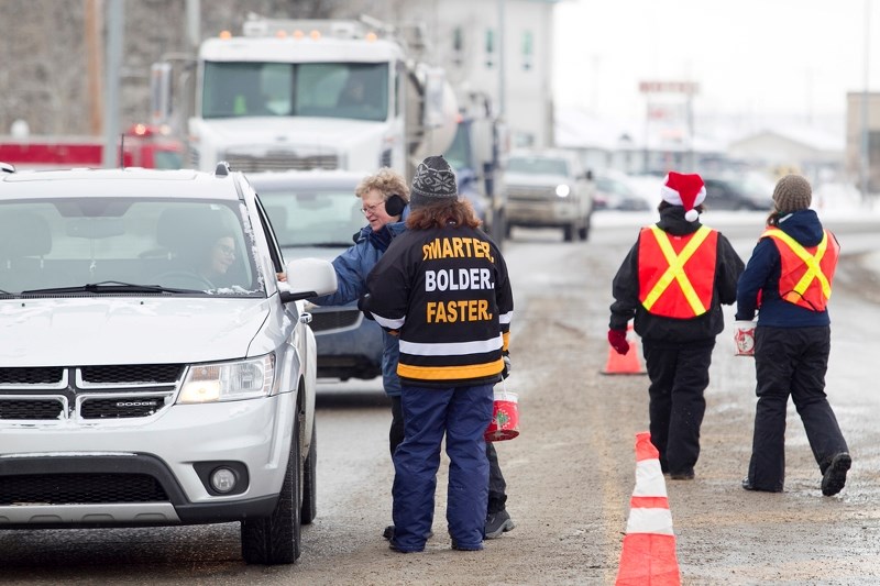 Sundre firefighter Rachel Klapp collects a donation from a passing motorist during the Charity Checkstop. Almost $10,000 was raised for the annual Sundre Santas program.