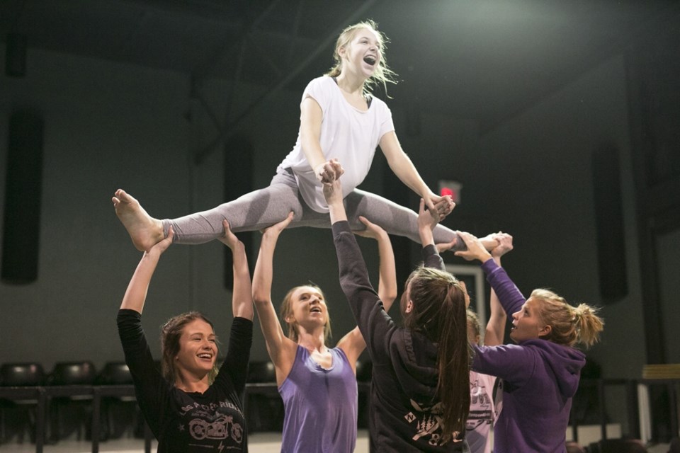 Studio K Dance Gallery members, from left, Ali Pedersen, Alysa Lund, Megan Moore and Jordin van Vlaanderen lift Meg Talbot into the air as instructor Nicky Shute, right,